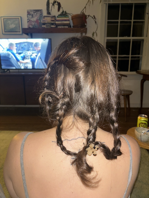 i braided s's hair in front of the tv