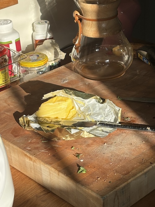 slab of butter on cutting board in sunlight