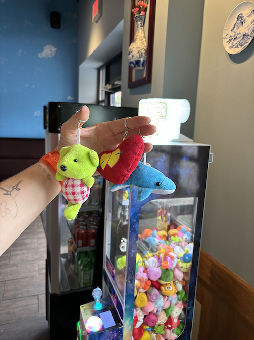 three keychains cy won from a clawmachine