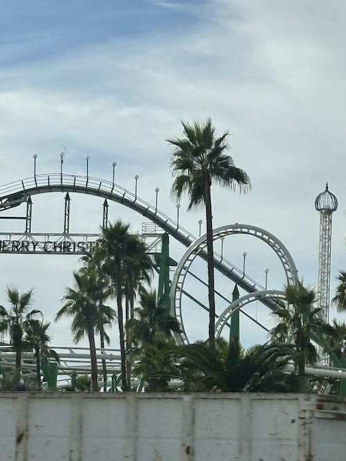 blurry photo of a theme park in arizona that says merry christmas on a roller coaster