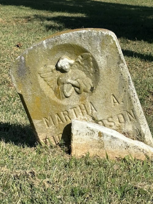 submerged grave in the grass, pretty angel