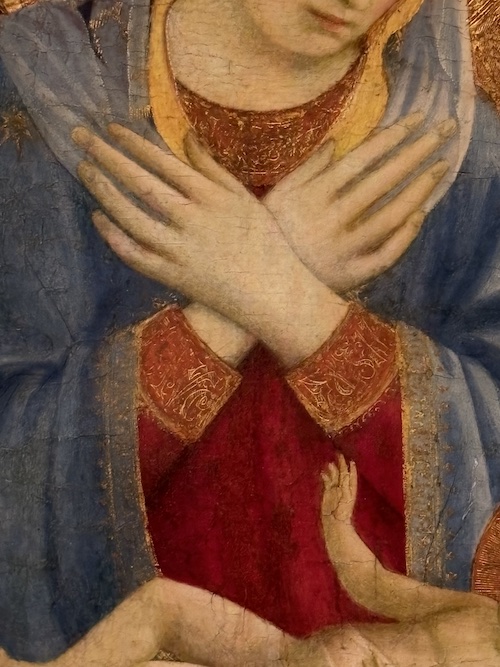 close up of mary's hands in a painting