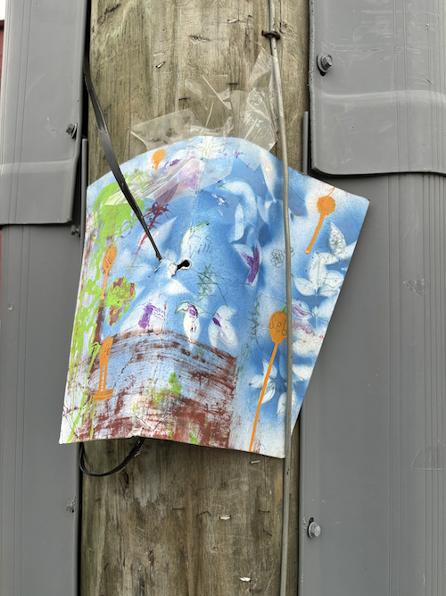 drawing tacked to a pole near the downtown mall